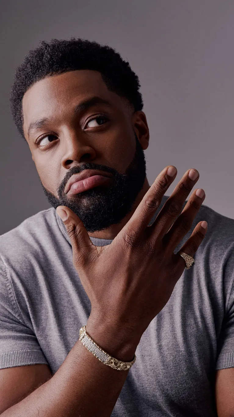 Close portrait of LaRoyce resting his chin on his hand