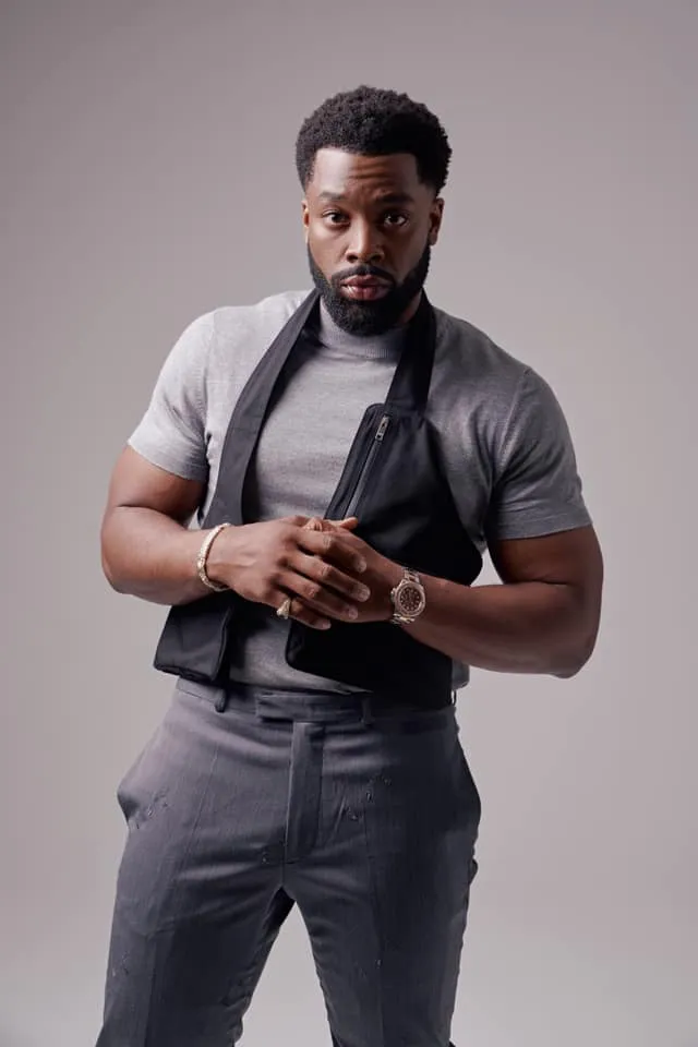 LaRoyce Hawkins in a grey tee and black vest